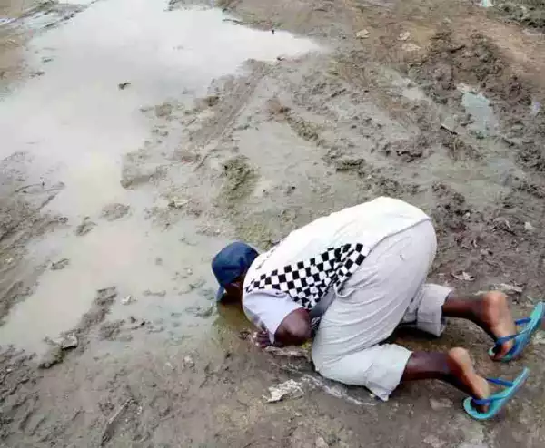 Nigerian Man Drinks Water From Dirty Ground Ahead Of Buhari Return (photo)
